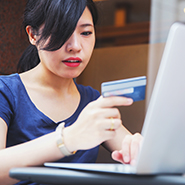 Asian women reading a debit card