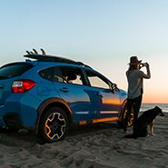 man and his dog outside the car