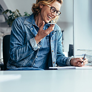 woman smiling while talking to phone