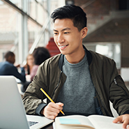 Young asian man looking at a computer screen
