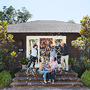 family celebrating outside of a home with confetti